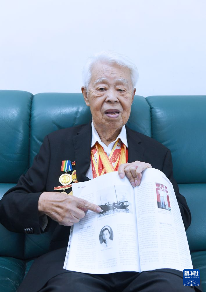 罗竞辉展示杂志上刊登的海上中队的木船历史照片(2025年10月28日摄)。 罗竞辉展示杂志上刊登的海上中队的木船历史照片(2025年10月28日摄)。