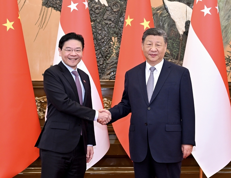 6月24日上午，国家主席习近平在北京人民大会堂会见来华进行正式访问的新加坡总理黄循财。图片来源：新华网